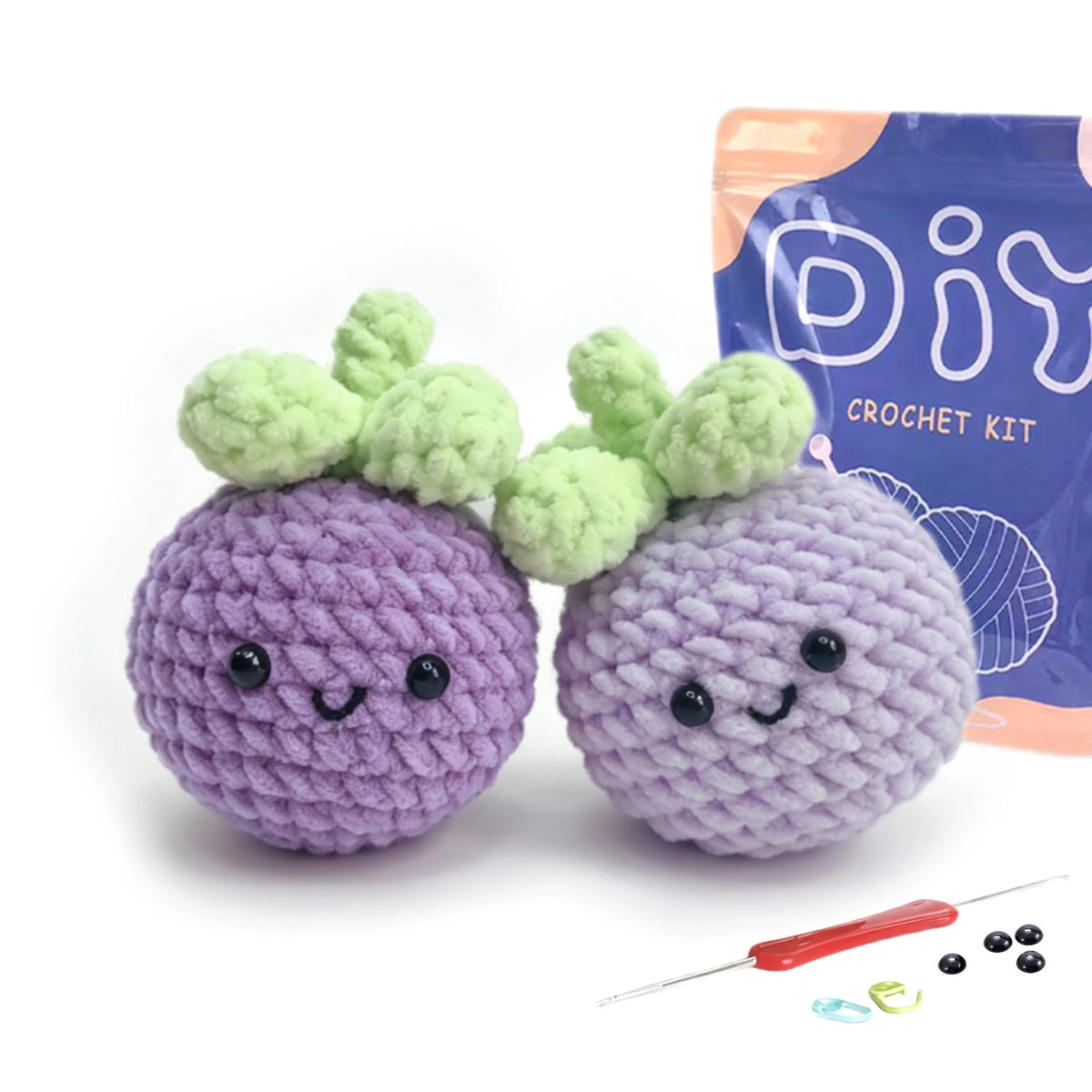 A purple crocheted animal with green leaves is shown next to its packaging and a crochet needle.