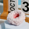 A pink, squishy stress relief ball with a red center is displayed next to a calendar showing October 3rd.