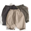 A pair of beige loose wide-leg harem pants for boys displayed flat.