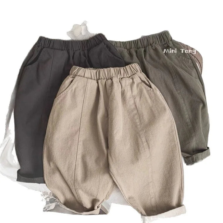 A pair of beige loose wide-leg harem pants for boys displayed flat.