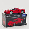 A red Enzo Ferrari Tomica die-cast sports car model displayed in its packaging.