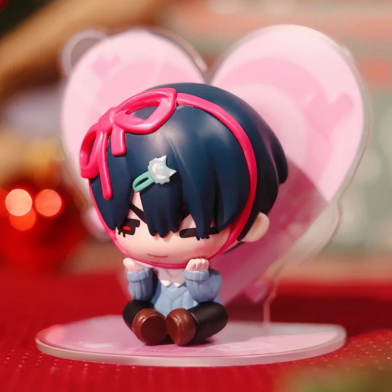 A mini figure collectible of a character with dark blue hair and pink accents, displayed against a heart-shaped background.
