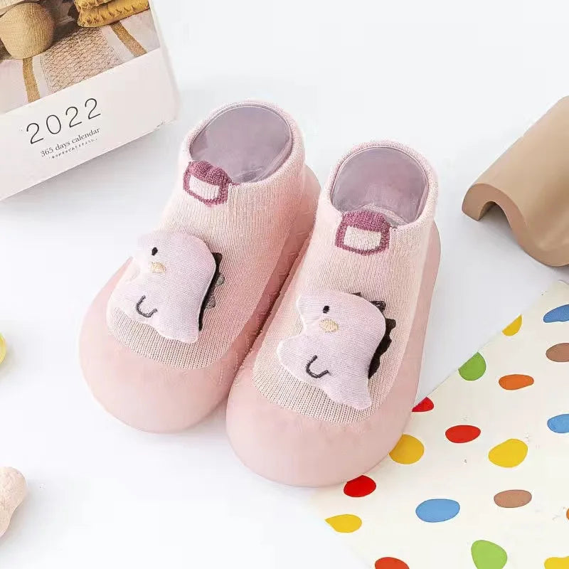 Pair of pink animal soft sole socks for babies and toddlers with a cute face design