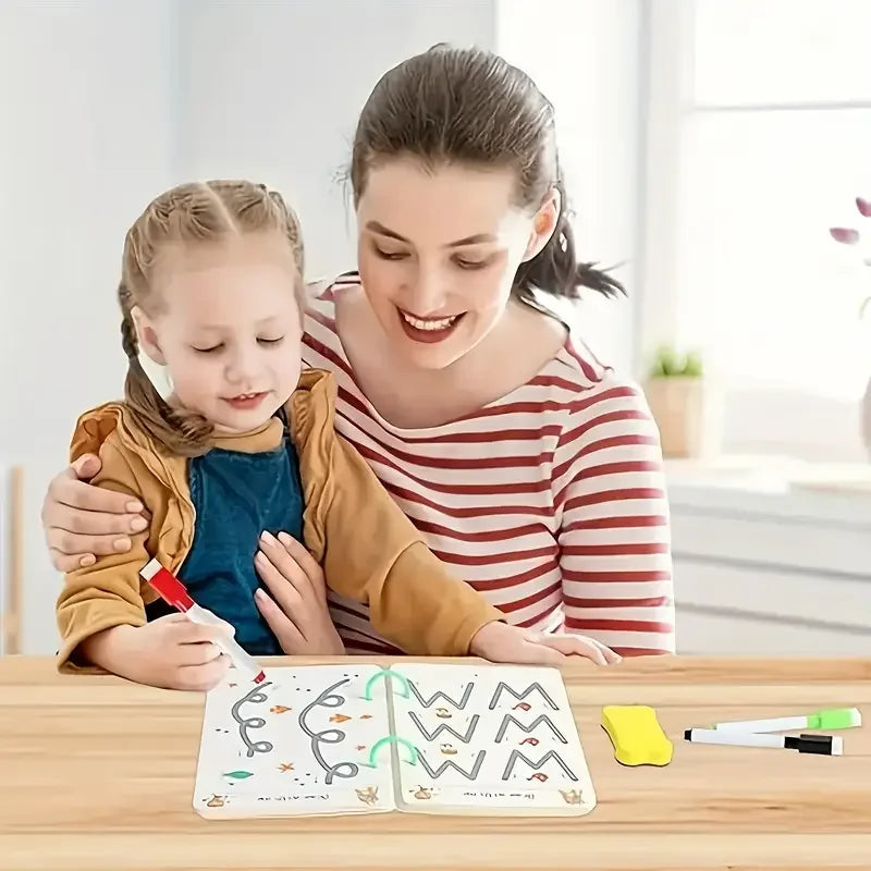 A smiling woman is helping a young girl draw in a reusable magic drawing workbook with pens and an eraser.