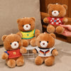 Three teddy bears wearing football jerseys, including one with a yellow jersey and two others in red and white.