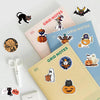 A collection of Halloween themed stickers featuring bats, cats, pumpkins, and ghosts on various colored paper sheets.