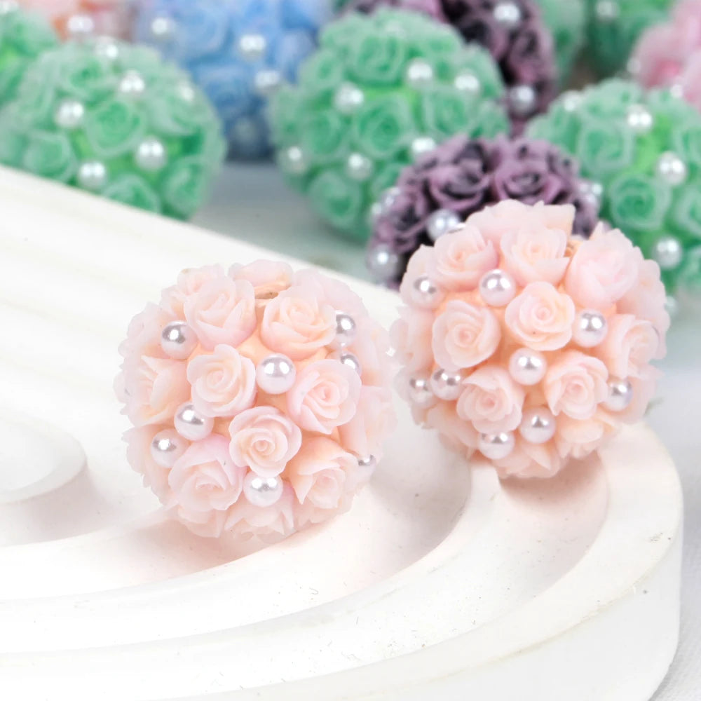 Pink rose flower ball acrylic beads for jewelry making displayed on a white surface.