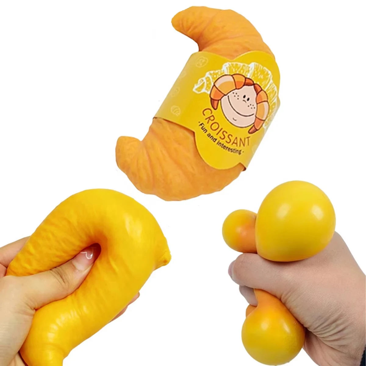 An orange squishy croissant stress relief toy is shown next to a yellow ball.