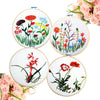 Four circular bamboo embroidery hoops featuring floral designs in red, pink, and blue threads.