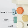 A close-up of a white Montessori screwdriver board toy showing various hexagonal and round inserts for fine motor skill pract