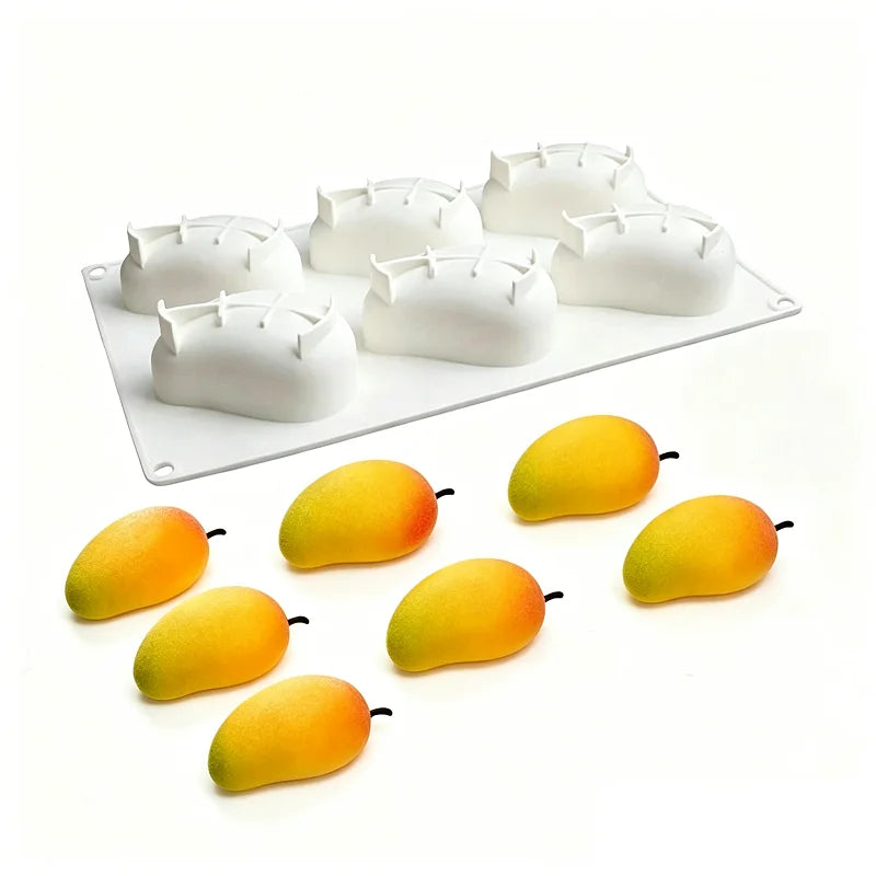 A white silicone mold with multiple fruit shapes, including pears and apples, resting on a white tray.