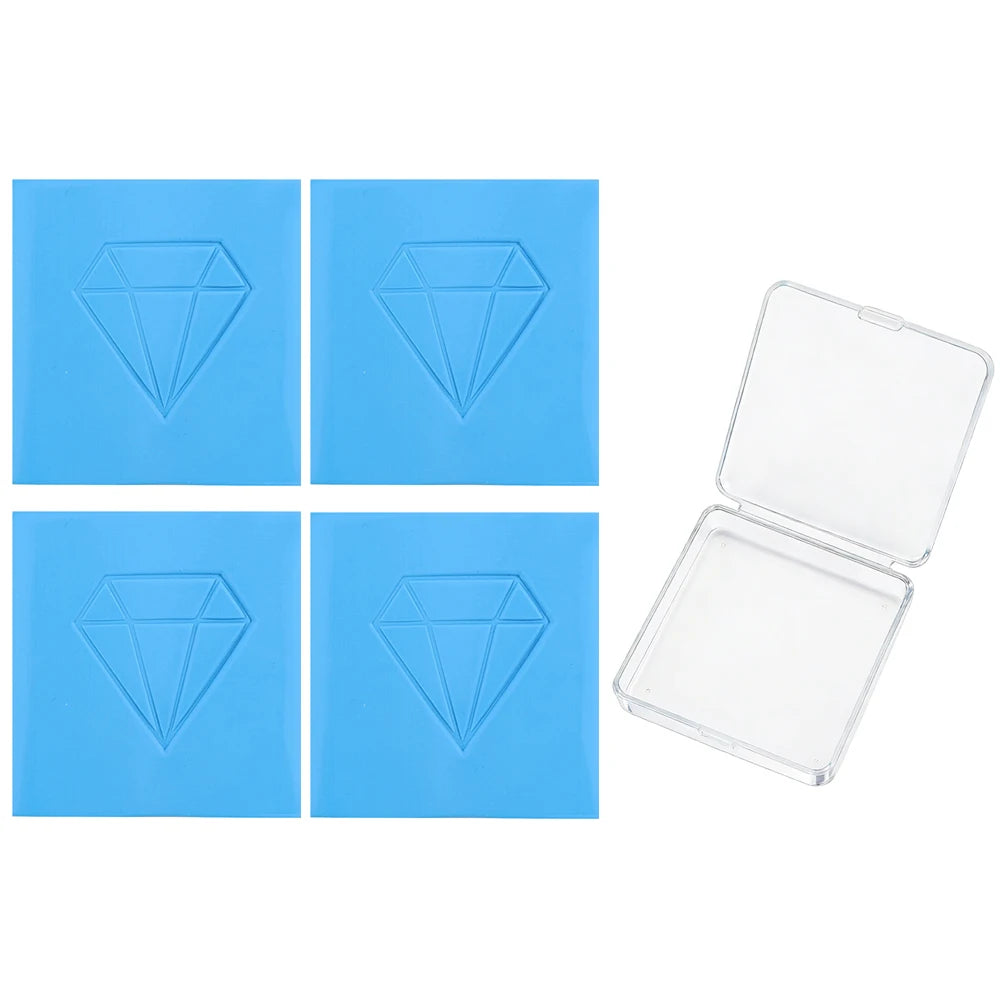 Four square blue wax pieces with diamond shapes and an open clear plastic container for diamond painting clay