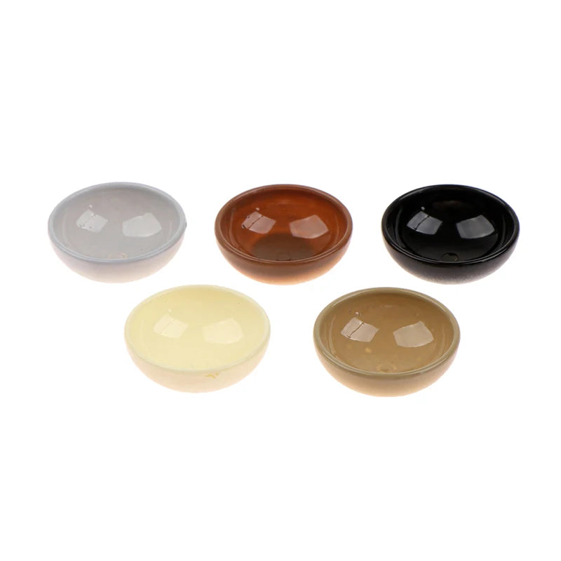 A set of five miniature dollhouse rice bowls in various earthy and dark tones.