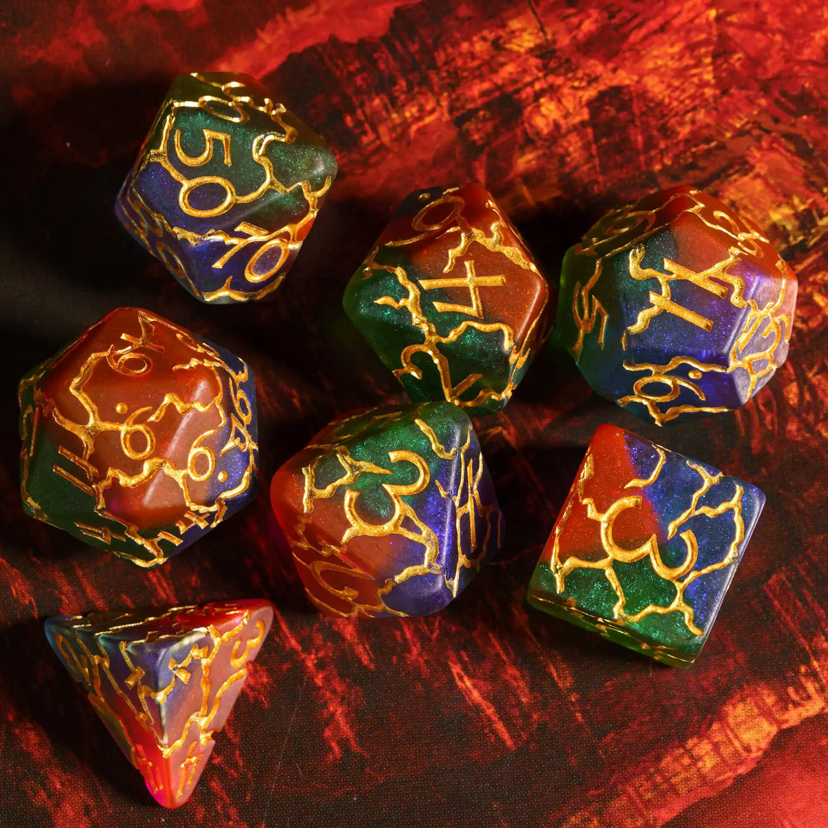 A set of seven frosted crack resin polyhedral dice in various shades of green, gold, and amber resting on a dark surface.