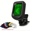 A black clip-on digital tuner is shown next to ten guitar picks in various colors.