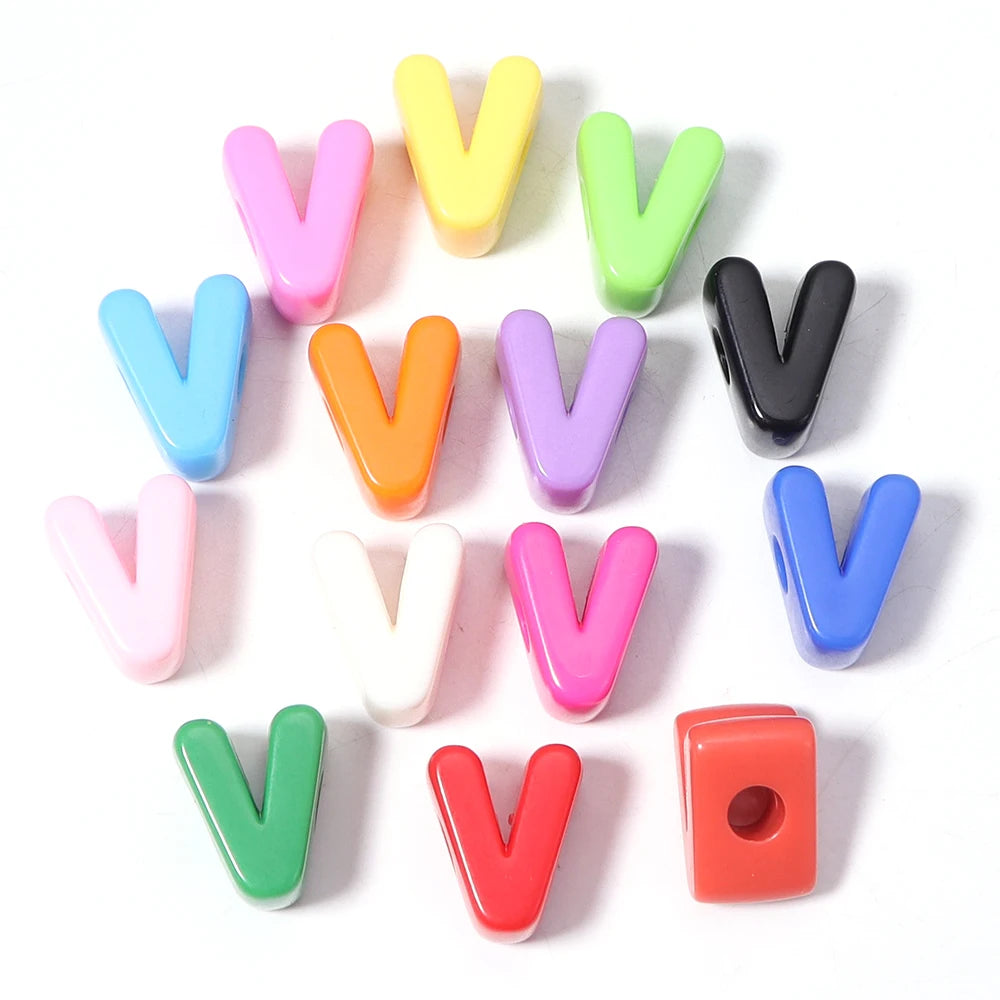 A collection of colorful acrylic letter V beads arranged in a circular pattern.