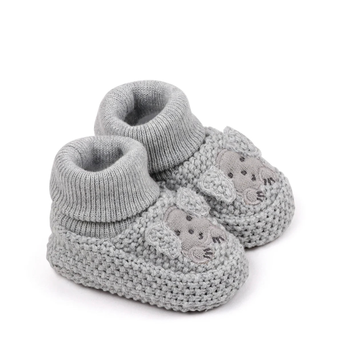 A pair of handmade knitted baby booties in light gray with a textured stitch pattern.