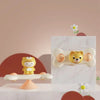 A yellow and white suction cup spinner bath toy for toddlers is displayed on a white surface.