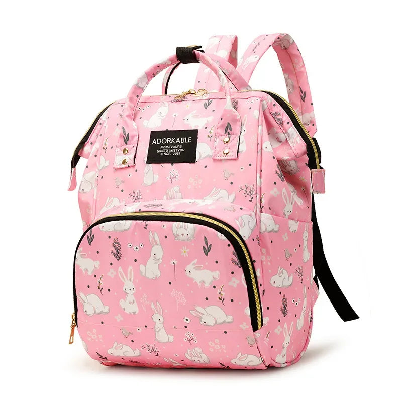 Pink cartoon print waterproof diaper bag with a black strap and yellow trim