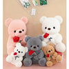 A collection of plush bears in pink, white, and gray colors with rose accents displayed on a light background.