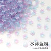 A pile of iridescent purple and blue sakura flower crystal glass beads for jewelry making.