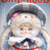 A fluffy doll wearing a plaid hat and traditional clothing is shown in a box art style.