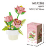 A set of 168 miniature pink and peach rose flowers in a bouquet arrangement with green leaves and a white pot.