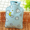 A light blue portable hot water bottle with a cloud design is shown on a woven surface.
