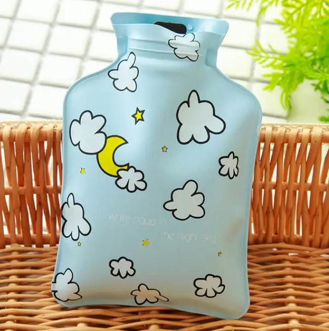 A light blue portable hot water bottle with a cloud design is shown on a woven surface.