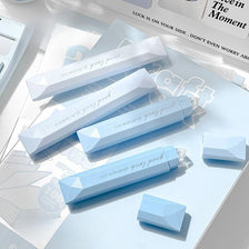 A close-up of four light blue adhesive dot tape glue rollers arranged on a white background.