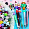 A collection of colorful silicone beads and a pen are displayed on a white dish against a pink background.