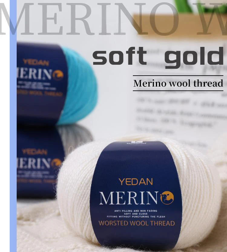 A ball of YEDAN MERINO soft gold wool thread is shown on a white surface.