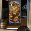 A DIY pirate ship book nook kit featuring a detailed wooden bookshelf insert model with miniature rigging and scenery.