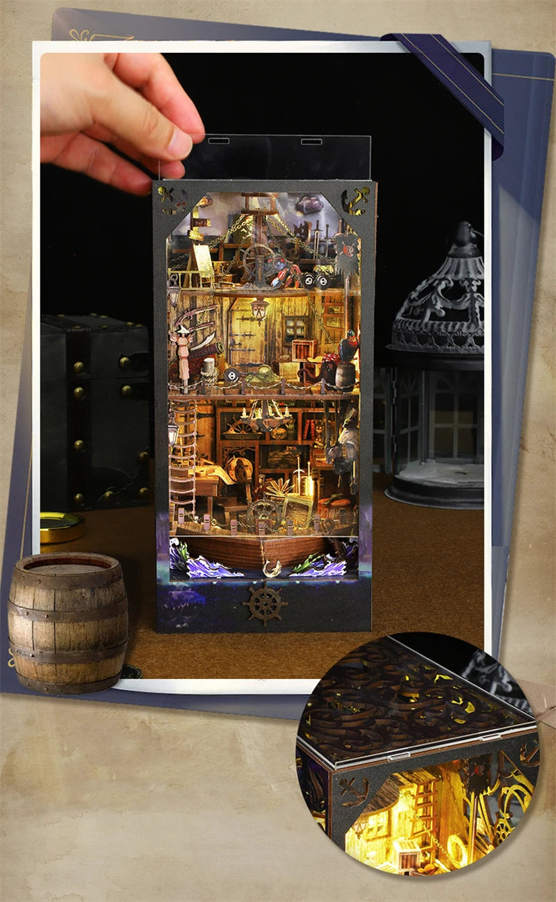 A DIY pirate ship book nook kit featuring a detailed wooden bookshelf insert model with miniature rigging and scenery.