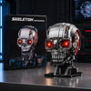 A detailed mechanical skeleton head building kit with LED lights displayed on a dark surface.