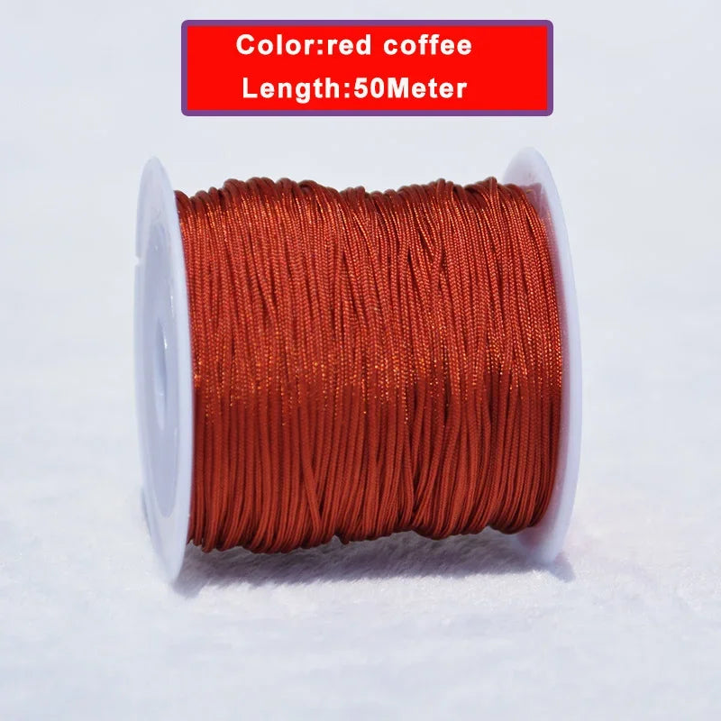 A spool of red coffee colored nylon knotting cord, 50 meters long, lying on a white surface.