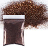 A dark bronze holographic glitter powder in a sealed bag next to loose glitter.
