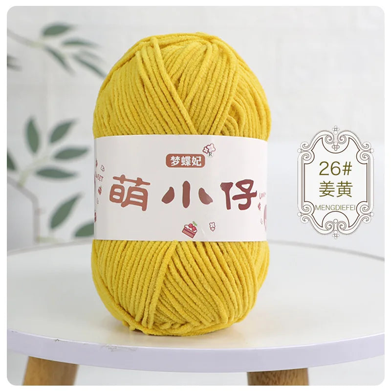 A ball of bright yellow chenille yarn labeled in Chinese characters for knitting and crochet.