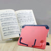 A pink adjustable portable book stand is shown next to sheet music and a book.