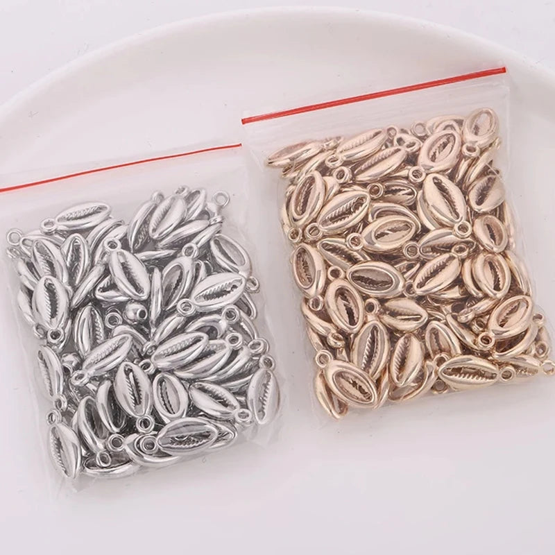 A small clear plastic bag contains 50 plastic seashell charms for jewelry making, featuring bohemian cowrie and conch pendant