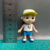 A playful cartoon PVC figurine of a child wearing a white shirt with a yellow watermelon design and blue shorts and shoes.