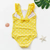 Yellow one-piece swimsuit for a child with white polka dots and ruffled trim