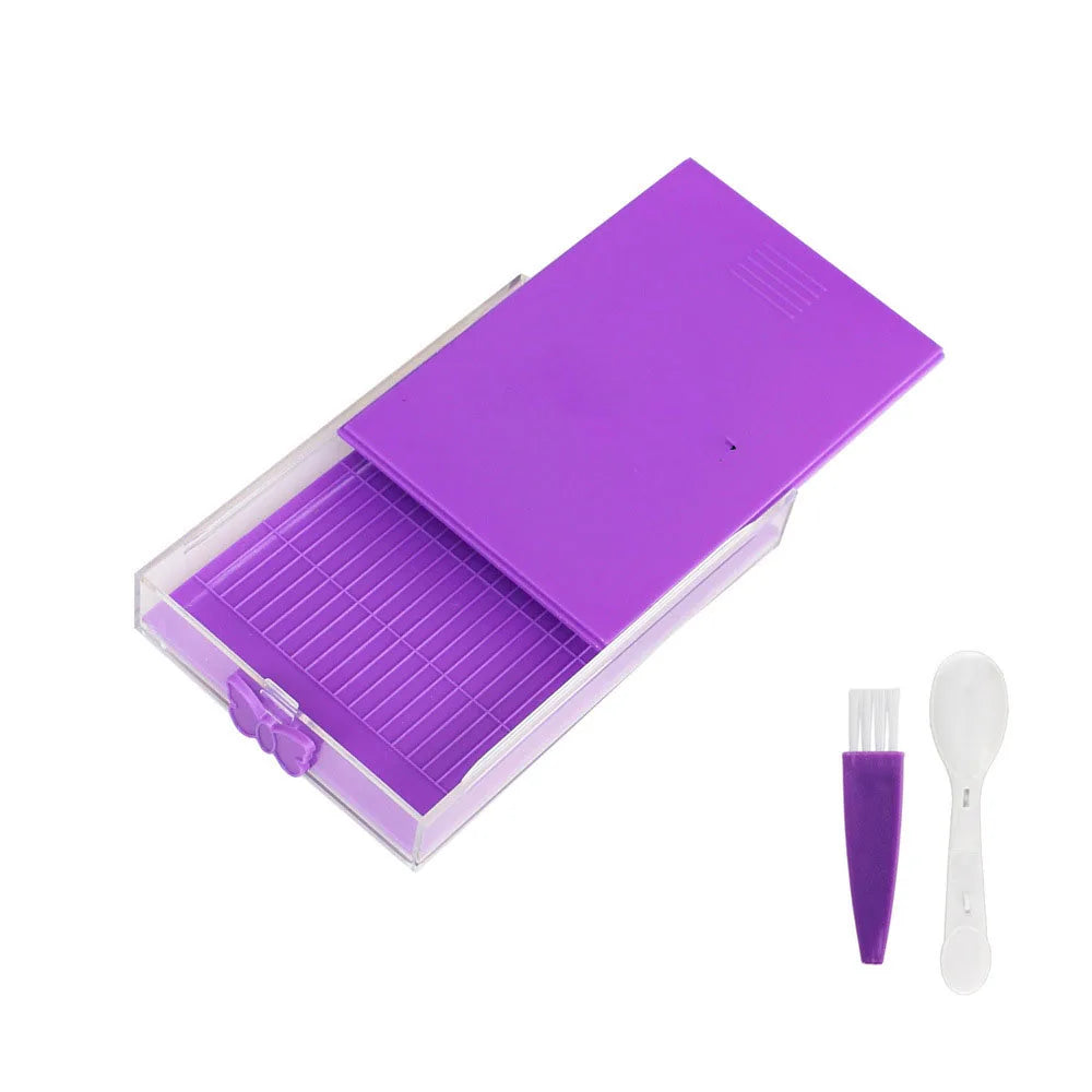 A purple diamond painting storage organizer box with a clear tray and a white tool.