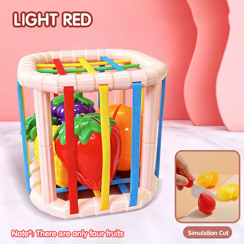 A light red plastic toy box containing four colorful fruits for a shape-sorting educational play set