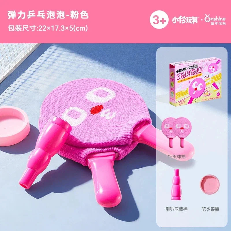 Pink handheld smoke bubble wand with a pink silicone body and a pink nozzle, shown on a light blue surface.