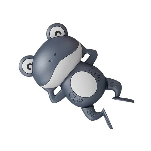 A gray and white wind-up swimming turtle bath toy.