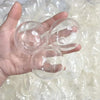 A hand holds three clear, spherical squishy stress ball covers with visible texture.