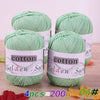 Four skeins of light green cotton knitting yarn for crochet and handmade projects