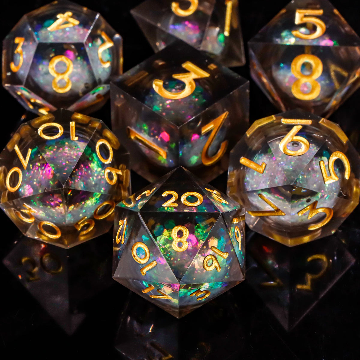A collection of translucent polyhedral dice with various numbers and colors resting on a dark surface.