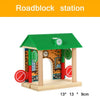 A wooden model of a roadblock station featuring brick walls and a green roof.